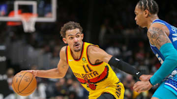 Dec 5, 2021; Atlanta, Georgia, USA; Atlanta Hawks guard Trae Young (11) dribbles the ball as Charlotte Hornets forward P.J. Washington (25) defends in the second half at State Farm Arena. Mandatory Credit: Brett Davis-USA TODAY Sports