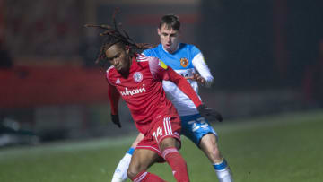 ACCRINGTON, ENGLAND - JANUARY 26: Tariq Uwakwe of Accrington Stanley and Gavin Whyte of Hull City in action during the Sky Bet League One match between Accrington Stanley and Hull City at The Crown Ground on January 26, 2021 in Accrington, England. Sporting stadiums around the UK remain under strict restrictions due to the Coronavirus Pandemic as Government social distancing laws prohibit fans inside venues resulting in games being played behind closed doors. (Photo by Joe Prior/Visionhaus)
