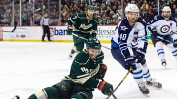 Jan 15, 2016; Saint Paul, MN, USA; Minnesota Wild forward Jarret Stoll (19) is tripped by Winnipeg Jets forward Joel Armia (40) during the first period at Xcel Energy Center. Mandatory Credit: Brace Hemmelgarn-USA TODAY Sports