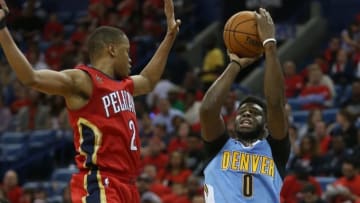Oct 26, 2016; New Orleans, LA, USA; Denver Nuggets guard Emmanuel Mudiay (0) takes a shot while defended by New Orleans Pelicans guard Tim Frazier (2) in the second quarter at the Smoothie King Center. Mandatory Credit: Chuck Cook-USA TODAY Sports