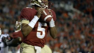 Jan 6, 2014; Pasadena, CA, USA; Florida State Seminoles quarterback Jameis Winston (5) throws against the Auburn Tigers during the first half of the 2014 BCS National Championship game at the Rose Bowl. Mandatory Credit: Richard Mackson-USA TODAY Sports