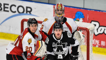 BOISBRIAND, QC - NOVEMBER 24: Xavier Bouchard #20 of the Baie-Comeau Drakkar and Alexandre Alain #7 of the Blainville-Boisbriand Armada battle for position in front of goaltender Antoine Samuel #35 during the QMJHL game at Centre d'Excellence Sports Rousseau on November 24, 2017 in Boisbriand, Quebec, Canada. The Blainville-Boisbriand Armada defeated the Baie-Comeau Drakkar 5-3. (Photo by Minas Panagiotakis/Getty Images)