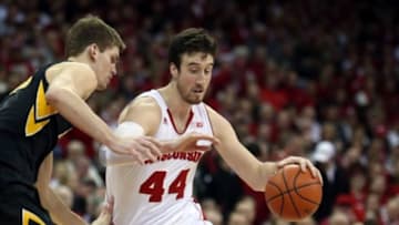Wisconsin Badgers forward Frank Kaminsky (44) takes the ball around Iowa Hawkeyes center Adam Woodbury (34) at the Kohl Center. Wisconsin defeated Iowa 82-50. Mandatory Credit: Mary Langenfeld-USA TODAY Sports