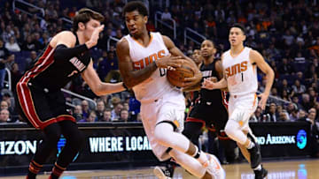 Jan 3, 2017; Phoenix, AZ, USA; Phoenix Suns forward Marquese Chriss (0) moves the ball in front of Miami Heat forward Luke Babbitt (5) in the first half of the NBA game at Talking Stick Resort Arena. Mandatory Credit: Jennifer Stewart-USA TODAY Sports