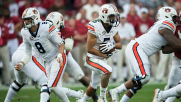 Auburn football quarterback Jarrett Stidham (8) was handed off to Auburn wide receiver Anthony Schwartz (5) during the Iron Bowl at Bryant-Denny Stadium in Tuscaloosa, Ala., on Saturday, Nov. 24, 2018. Alabama leads Auburn 17-14 at halftime.Jc Auburnbama 39