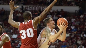 Nov 29, 2015; Norman, OK, USA; Oklahoma Sooners forward Ryan Spangler (00) is fouled on a shot attempt by Wisconsin Badgers forward Vitto Brown (30) during the second half at Lloyd Noble Center. Mandatory Credit: Mark D. Smith-USA TODAY Sports