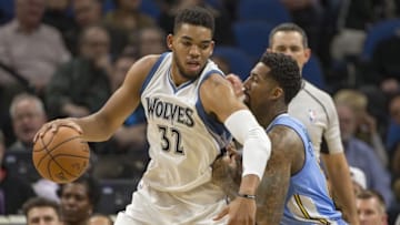 Nov 3, 2016; Minneapolis, MN, USA; Minnesota Timberwolves center Karl-Anthony Towns (32) dribbles the ball as Denver Nuggets forward Wilson Chandler (21) defends in the first half at Target Center. Mandatory Credit: Jesse Johnson-USA TODAY Sports