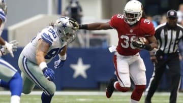 Nov 2, 2014; Arlington, TX, USA; Arizona Cardinals running back Andre Ellington (38) runs the ball while defended by Dallas Cowboys defensive tackle Nick Hayden (96) in the first quarter at AT&T Stadium. Mandatory Credit: Tim Heitman-USA TODAY Sports