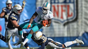 Nov 13, 2016; San Diego, CA, USA; Miami Dolphins wide receiver DeVante Parker (11) is tackled by San Diego Chargers strong safety Craig Mager (29) and outside linebacker Kyle Emanuel (51) during the second quarter after a catch at Qualcomm Stadium. Mandatory Credit: Jake Roth-USA TODAY Sports