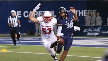 Sep 3, 2015; Logan, UT, USA; Utah State Aggies quarterback Chuckie Keeton (16) avoids a tackle by Southern Utah Thunderbirds defensive end James Cowser (53) during the fourth quarter at Romney Stadium. Utah State Aggies won the game 12-9. Mandatory Credit: Chris Nicoll-USA TODAY Sports