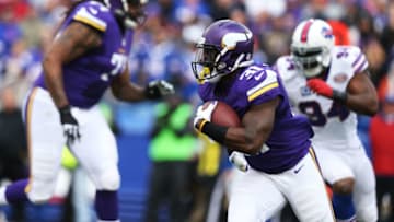 ORCHARD PARK, NY - OCTOBER 19: Jerick McKinnon #31 of the Minnesota Vikings runs the ball as Mario Williams #94 of the Buffalo Bills gives chase during the first half at Ralph Wilson Stadium on October 19, 2014 in Orchard Park, New York. (Photo by Brett Carlsen/Getty Images)
