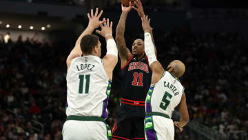 MILWAUKEE, WISCONSIN - APRIL 17: DeMar DeRozan #11 of the Chicago Bulls shoots over Brook Lopez #11 and Jevon Carter #5 of the Milwaukee Bucks during the second quarter of Game One of the Eastern Conference First Round Playoffs at Fiserv Forum on April 17, 2022 in Milwaukee, Wisconsin. NOTE TO USER: User expressly acknowledges and agrees that, by downloading and or using this photograph, User is consenting to the terms and conditions of the Getty Images License Agreement. (Photo by Stacy Revere/Getty Images)