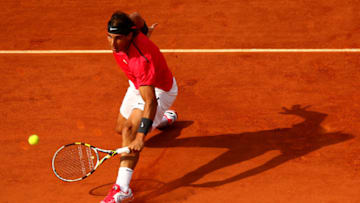 PARIS, FRANCE - JUNE 02: Rafael Nadal of Spain slides across the clay to play a backhand during his men's singles third round match against Eduardo Schwank of Argentina during day seven of the French Open at Roland Garros on June 2, 2012 in Paris, France. (Photo by Clive Brunskill/Getty Images)