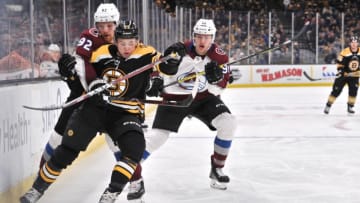 BOSTON, MA - FEBRUARY 10: Boston Bruins Defenceman Charlie McAvoy (73) get held back by Colorado Avalanche Left Wing Gabriel Landeskog (92). During the Boston Bruins game against the Colorado Avalanche on February 10, 2019 at TD Garden in Boston, MA.(Photo by Michael Tureski/Icon Sportswire via Getty Images)