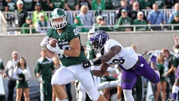 Oct 15, 2016; East Lansing, MI, USA; Michigan State Spartans tight end Josiah Price (82) makes a catch for a touchdown against Northwestern Wildcats defensive back Trae Williams (29) during the first quarter of a game at Spartan Stadium. Mandatory Credit: Mike Carter-USA TODAY Sports