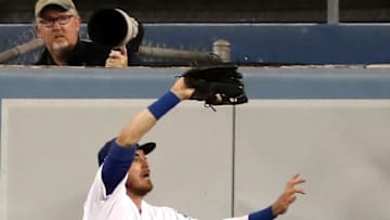 LOS ANGELES, CALIFORNIA - OCTOBER 09: Cody Bellinger #35 of the Los Angeles Dodgers makes a catch on the wall on a hit by Howie Kendrick #47 of the Washington Nationals for an out in the fourth inning of game five of the National League Division Series at Dodger Stadium on October 09, 2019 in Los Angeles, California. (Photo by Sean M. Haffey/Getty Images)