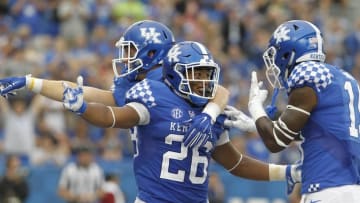 Sep 17, 2016; Lexington, KY, USA; Kentucky Wildcats running back Benny Snell Jr (26) celebrates with teammates after scoring a touchdown against the New Mexico State Aggies in the second half at Commonwealth Stadium. Kentucky defeated New Mexico State 62-42. Mandatory Credit: Mark Zerof-USA TODAY Sports