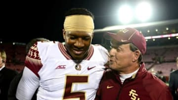 Oct 30, 2014; Louisville, KY, USA; Florida State Seminoles quarterback Jameis Winston (5) and head coach Jimbo Fisher walk off the field after defeating the Louisville Cardinals 42-31 at Papa John