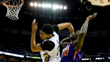 Apr 10, 2015; New Orleans, LA, USA; New Orleans Pelicans forward Anthony Davis (23) reacts after taking a blow to the head from Phoenix Suns forward Earl Barron (30) during the second quarter of a game at the Smoothie King Center. Davis would leave the game following the play. Mandatory Credit: Derick E. Hingle-USA TODAY Sports