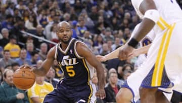 Nov 16, 2013; Oakland, CA, USA; Utah Jazz guard John Lucas III (5) dribbles the ball against the Golden State Warriors in the third quarter at Oracle Arena. The Warriors defeated the Jazz 102-88. Mandatory Credit: Cary Edmondson-USA TODAY Sports