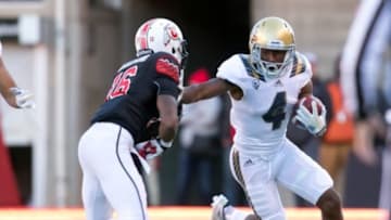 Nov 21, 2015; Salt Lake City, UT, USA; UCLA Bruins wide receiver Darren Andrews (4) carries the ball as Utah Utes defensive back Cory Butler-Byrd (16) defends during the second half at Rice-Eccles Stadium. UCLA won 17-9. Mandatory Credit: Russ Isabella-USA TODAY Sports