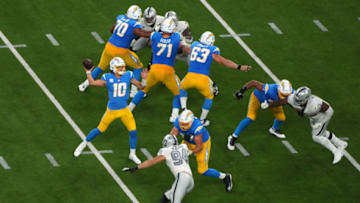 NFL playoff scenarios; Los Angeles Chargers quarterback Justin Herbert (10) throws a pass against the Las Vegas Raiders during the first half at SoFi Stadium. Mandatory Credit: Kirby Lee-USA TODAY Sports