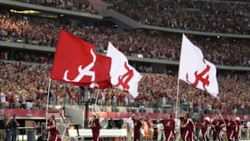 Sep 1, 2012; Arlington, TX, USA; Alabama Crimson Tide cheerleaders waves the flags prior to the game against the Michigan Wolverines at Cowboys Stadium. Mandatory Credit: Matthew Emmons-USA TODAY Sports
