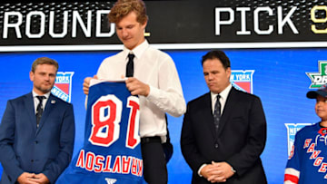 Jun 22, 2018; Dallas, TX, USA; Vitali Kravtsov puts on a team jersey after being selected as the number nine overall pick to the New York Rangers in the first round of the 2018 NHL Draft at American Airlines Center. Mandatory Credit: Jerome Miron-USA TODAY Sports