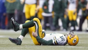 January 18, 2015; Seattle, WA, USA; Green Bay Packers quarterback Aaron Rodgers (12) lays on the field after being brought down by the Seattle Seahawks defense during the second half in the NFC Championship game at CenturyLink Field. Mandatory Credit: Joe Nicholson-USA TODAY Sports