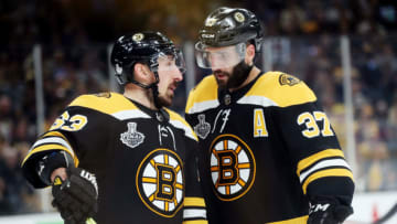 BOSTON, MASSACHUSETTS - JUNE 06: Brad Marchand #63 and Patrice Bergeron #37 of the Boston Bruins speak during a timeout against the St. Louis Blues during the third period in Game Five of the 2019 NHL Stanley Cup Final at TD Garden on June 06, 2019 in Boston, Massachusetts. (Photo by Adam Glanzman/Getty Images)