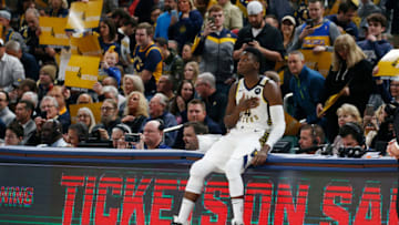 Jan 29, 2020; Indianapolis, Indiana, USA; Indiana Pacers guard Victor Oladipo (4) sits on the scorer's table waiting to enter the game in his return to the court for the first time from a season ending injury. He retuned during the first half against the Chicago Bulls at Bankers Life Fieldhouse. Mandatory Credit: Brian Spurlock-USA TODAY Sports