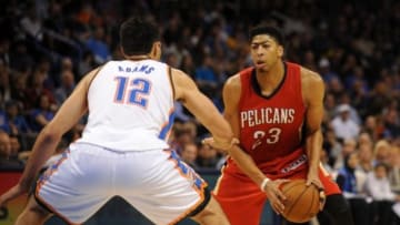 Dec 21, 2014; Oklahoma City, OK, USA; New Orleans Pelicans forward Anthony Davis (23) handles the ball against Oklahoma City Thunder center Steven Adams (12) during the third quarter at Chesapeake Energy Arena. Mandatory Credit: Mark D. Smith-USA TODAY Sports