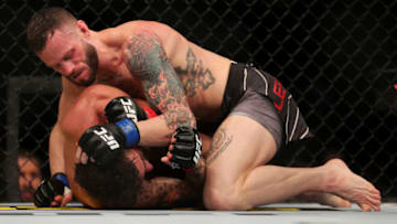 LAS VEGAS, NEVADA - DECEMBER 11: Tony Kelley (top) strikes Randy Costa during their bantamweight  fight in the UFC 269 event at T-Mobile Arena on December 11, 2021 in Las Vegas, Nevada. (Photo by Carmen Mandato/Getty Images)