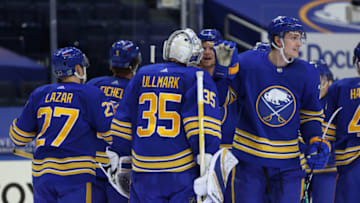 Jan 30, 2021; Buffalo, New York, USA; Buffalo Sabres goaltender Linus Ullmark (35) celebrates his shootout win against the New Jersey Devils with teammates at KeyBank Center. Mandatory Credit: Timothy T. Ludwig-USA TODAY Sports