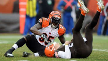 Dec 14, 2014; Cleveland, OH, USA; Cincinnati Bengals defensive end Wallace Gilberry (95) and Cleveland Browns quarterback Johnny Manziel (2) after a sack during the first quarter at FirstEnergy Stadium. Mandatory Credit: Ken Blaze-USA TODAY Sports
