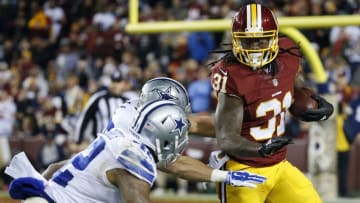 Dec 7, 2015; Landover, MD, USA; Washington Redskins running back Matt Jones (31) carries the ball as Dallas Cowboys outside linebacker Sean Lee (50) and Dallas Cowboys strong safety Barry Church (42) chase in the second quarter at FedEx Field. Mandatory Credit: Geoff Burke-USA TODAY Sports