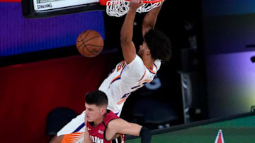 LAKE BUENA VISTA, FLORIDA - AUGUST 08: Cameron Johnson #23 of the Phoenix Suns dunks the ball against Tyler Herro #14 of the Miami Heat during the first half of an NBA basketball game at Visa Athletic Center at ESPN Wide World Of Sports Complex on August 8, 2020 in Lake Buena Vista, Florida. NOTE TO USER: User expressly acknowledges and agrees that, by downloading and or using this photograph, User is consenting to the terms and conditions of the Getty Images License Agreement. (Photo by Ashley Landis - Pool/Getty Images)