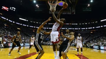 Jun 12, 2014; Miami, FL, USA; Miami Heat guard Mario Chalmers (15) shoots against San Antonio Spurs forward Tim Duncan (21) during the third quarter of game four of the 2014 NBA Finals at American Airlines Arena. Mandatory Credit: Bob Donnan-USA TODAY Sports