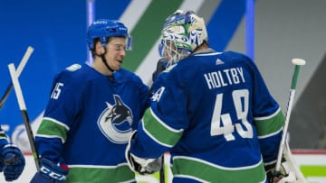 Apr 20, 2021; Vancouver, British Columbia, CAN; Vancouver Canucks forward Matthew Highmore (15) and goalie Braden Holtby (49) celebrate the Canucks victory against the Toronto Maple Leafs in the third period at Rogers Arena. Canucks won 6-3. Mandatory Credit: Bob Frid-USA TODAY Sports