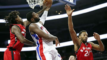Oct 19, 2016; Auburn Hills, MI, USA; Detroit Pistons center Andre Drummond (0) attempts a shot against Toronto Raptors center Lucas Nogueira (92) and guard Norman Powell (24) during the fourth quarter at The Palace of Auburn Hills. Raptors won 103-92. Mandatory Credit: Raj Mehta-USA TODAY Sports