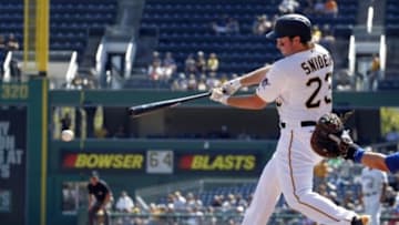 Sep 15, 2015; Pittsburgh, PA, USA; Pittsburgh Pirates left fielder Travis Snider (23) hits a two run single against the Chicago Cubs during the first inning at PNC Park. Mandatory Credit: Charles LeClaire-USA TODAY Sports