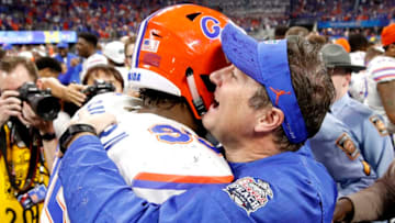ATLANTA, GEORGIA - DECEMBER 29: Jabari Zuniga #92 of the Florida Gators and head coach Dan Mullen celebrate after their teams win over the Michigan Wolverines during the Chick-fil-A Peach Bowl at Mercedes-Benz Stadium on December 29, 2018 in Atlanta, Georgia. The Gators defeated the Wolverines 41-15. (Photo by Joe Robbins/Getty Images)