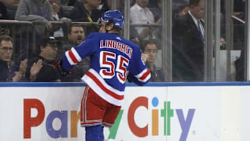 NEW YORK, NEW YORK - JANUARY 07: Ryan Lindgren #55 of the New York Rangers hits Joonas Donskoi #72 of the Colorado Avalanche into the boards during the first period at Madison Square Garden on January 07, 2020 in New York City. (Photo by Bruce Bennett/Getty Images)