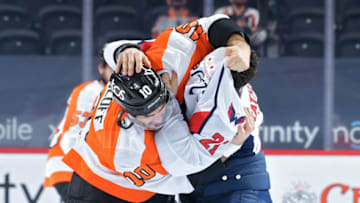 PHILADELPHIA, PA - MARCH 11: Garnet Hathaway #21 of the Washington Capitals and Andy Andreoff #10 of the Philadelphia Flyers fight in the first period at Wells Fargo Center on March 11, 2021 in Philadelphia, Pennsylvania. (Photo by Drew Hallowell/Getty Images)