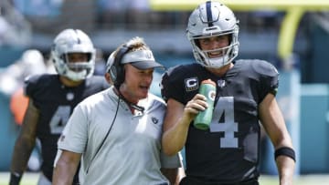 MIAMI, FL - SEPTEMBER 23: Derek Carr #4 of the Oakland Raiders and head coach Jon Gruden of the Oakland Raiders during the second quarter against Miami Dolphins at Hard Rock Stadium on September 23, 2018 in Miami, Florida. (Photo by Mark Brown/Getty Images)