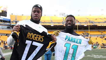 Jan 8, 2017; Pittsburgh, PA, USA; Miami Dolphins wide receiver DeVante Parker (11) exchanges jerseys with Pittsburgh Steelers wide receiver Eli Rogers (17) after the AFC Wild Card playoff football game at Heinz Field. The Steelers won 30-12. Mandatory Credit: Charles LeClaire-USA TODAY Sports