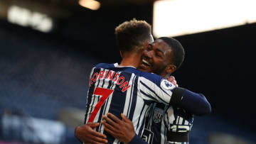 WEST BROMWICH, ENGLAND - APRIL 12: Callum Robinson of West Bromwich Albion celebrates scoring his sides third goal with Ainsley Maitland-Niles of West Bromwich Albion during the Premier League match between West Bromwich Albion and Southampton at The Hawthorns on April 12, 2021 in West Bromwich, England. Sporting stadiums around the UK remain under strict restrictions due to the Coronavirus Pandemic as Government social distancing laws prohibit fans inside venues resulting in games being played behind closed doors. (Photo by Catherine Ivill/Getty Images)