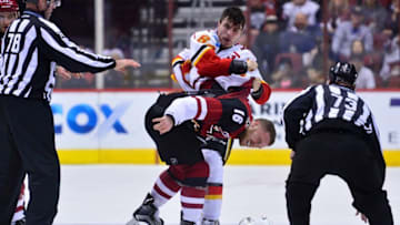 Dec 8, 2016; Glendale, AZ, USA; Calgary Flames right wing Garnet Hathaway (64) punches Arizona Coyotes left wing Max Domi (16) during the second period at Gila River Arena. Mandatory Credit: Matt Kartozian-USA TODAY Sports