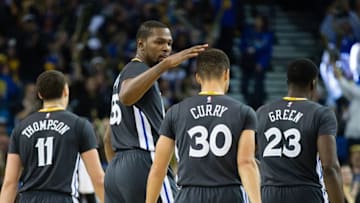 Dec 17, 2016; Oakland, CA, USA; Golden State Warriors forward Kevin Durant (35) pats guard Stephen Curry (30) on the head as a timeout is called against the Portland Trail Blazers during the third quarter at Oracle Arena. The Golden State Warriors defeated the Portland Trail Blazers 135-90. Mandatory Credit: Kelley L Cox-USA TODAY Sports
