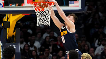 Jan 20, 2023; Denver, Colorado, USA; Denver Nuggets guard Christian Braun (0) dunks the ball during the second half against the Indiana Pacers at Ball Arena. Mandatory Credit: Ron Chenoy-USA TODAY Sports